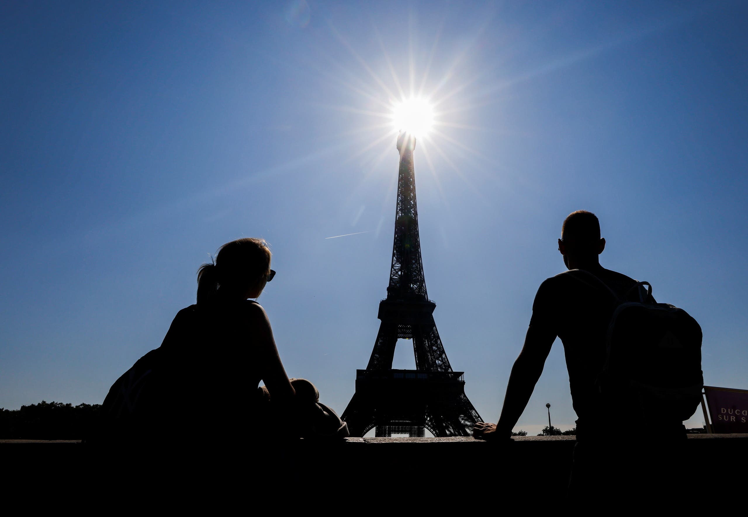 Tourists visit the famous Eiffel Tower in Paris