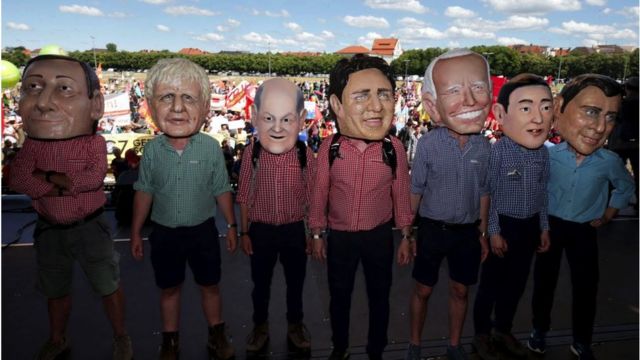 G7 leaders appear as puppets during a rally in Munich