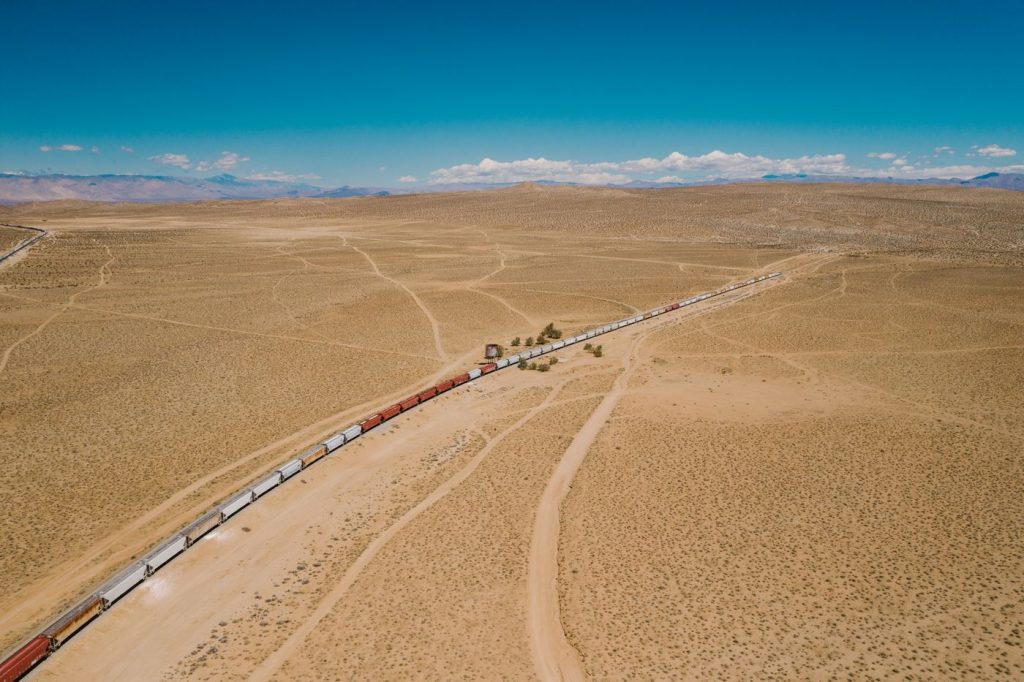 What the UAE’s Hormuz bypass means for Gulf supply chains A long freight train crossing open desert