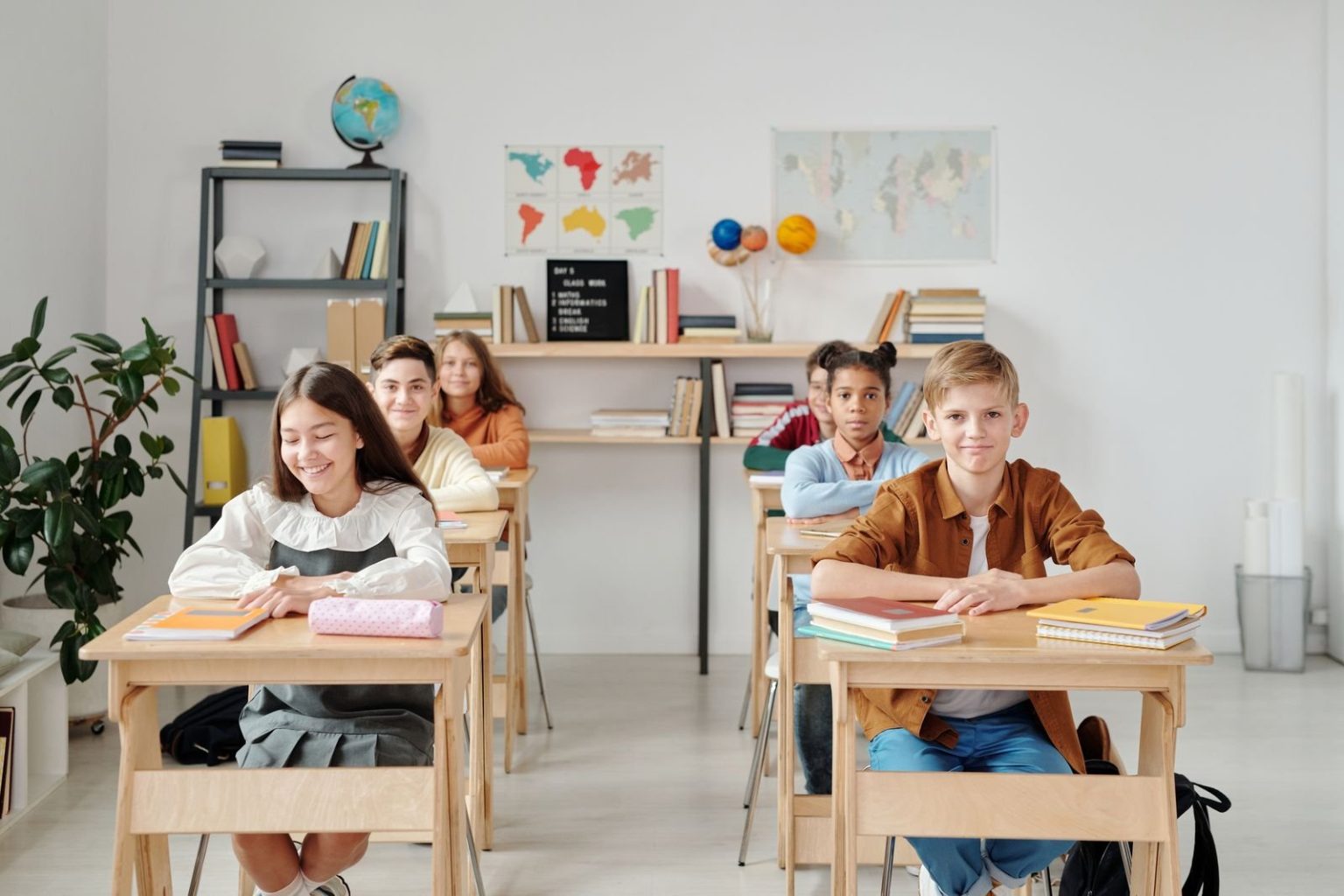 Students at desks in a classroom, as OFG Education buys an Ajman private school