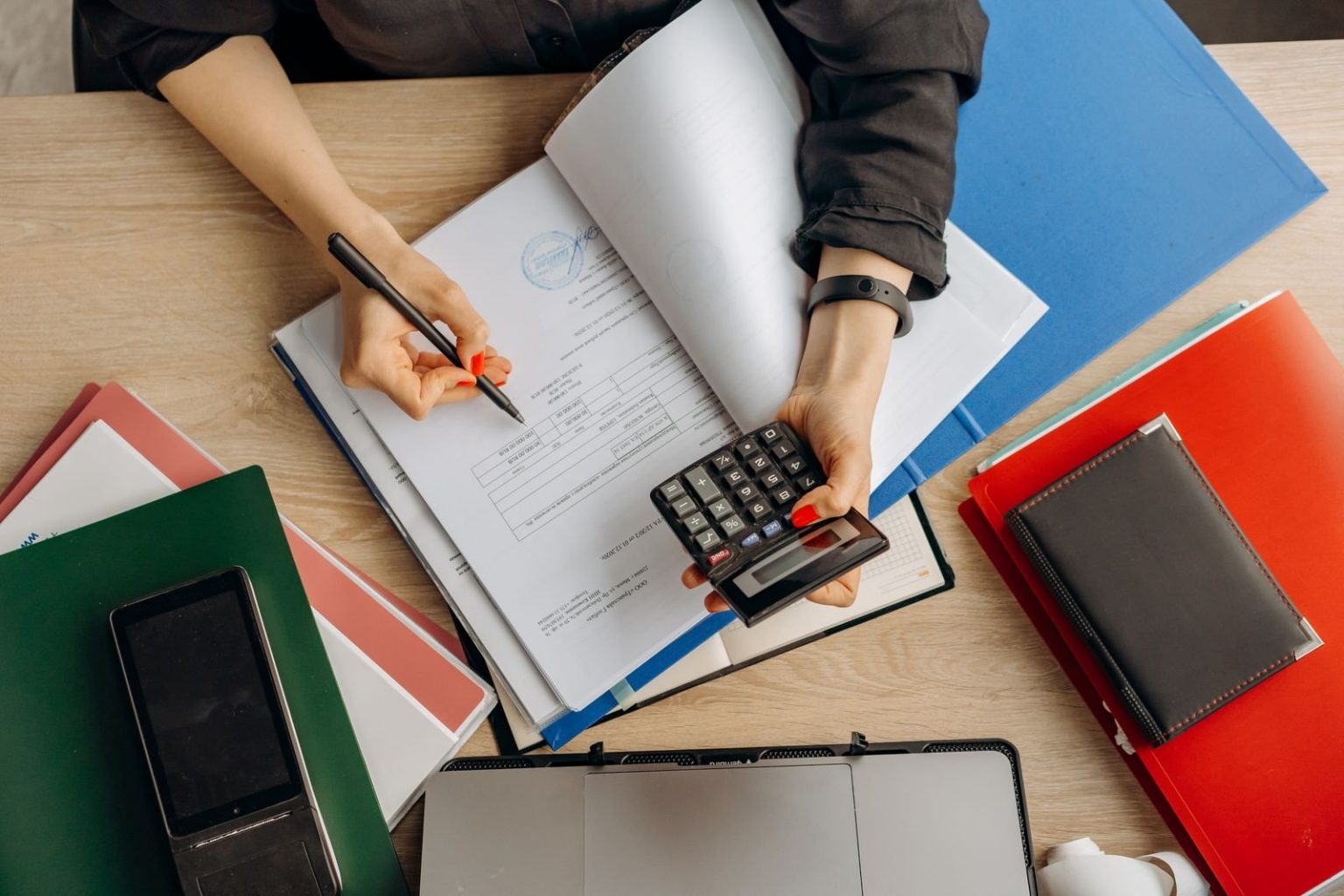 Dubai-raised Ayaan Mandelia, 15, recognised by Guinness World Records as youngest chartered accountant (male) Accountant reviewing financial documents with a calculator