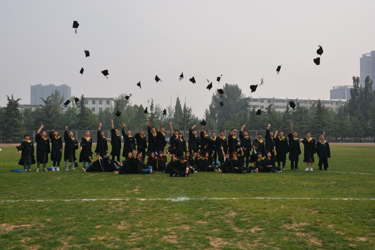 Middlesex University Dubai on course for largest graduating class with more than 2,750 students Graduates throwing their caps in the air at a graduation ceremony